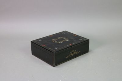 a black box with a clock on it on a white surface