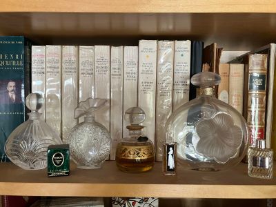 a book shelf with a lot of bottles and books on it