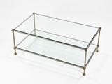 a glass and brass coffee table on a white background