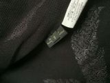the label on a black jacket is attached to the back of the jacket