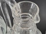 a clear glass pitcher sitting on top of a table