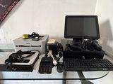 a desk with a computer, keyboard, mouse, and other electronics on it
