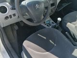 the interior of a small car with a steering wheel and dashboard