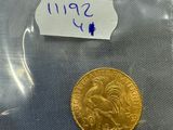 a close up of a gold coin in a plastic bag on a table