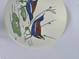 a plate with a picture of two birds on it