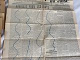 newspapers are laying on a bed with a person drawing on them