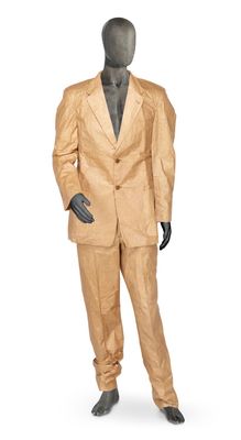 a mannequin dressed in a tan suit and black shoes