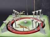a small model of a circus with horses and people on it