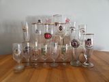 a lot of wine glasses sitting on a wooden table