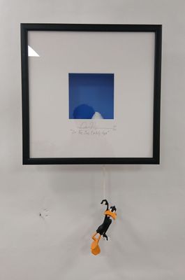 a picture of a picture of a dog hanging on a wall