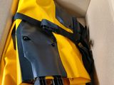 a yellow and black bag inside of a cardboard box