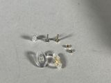 some screws and screws are laying on a white surface