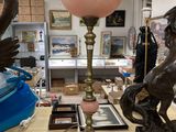 a table with a lamp and a statue on it
