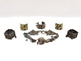 several pieces of jewelry are arranged in a circle on a white surface