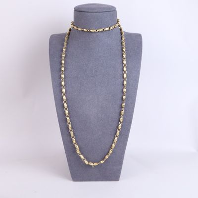 a gold chain necklace on a mannequin mannequin display