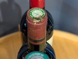three bottles of wine are stacked on top of each other on a table