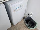 a small kitchen with a washing machine and a coffee maker