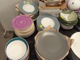 a lot of plates and bowls on the table