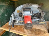 a picture of a power drill and a corded drill on a wooden table