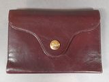 an image of a red leather wallet with a gold button