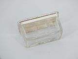 an image of a clear glass box with a handle on a white surface