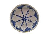 a blue and white plate with a snowflake design on it
