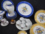many plates and cups that are sitting on a table