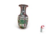 a vase with a painting on it sitting on a white surface
