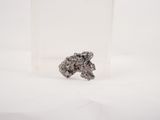 a small piece of silver on a white surface