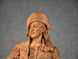 a statue of a man with a hat on a table