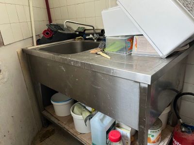 a kitchen with a sink and a microwave on the counter