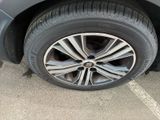 a close up of a tire on a car in a parking lot