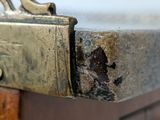 a close up of a piece of metal on a wooden table