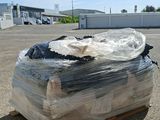 a large pile of plastic wrap sitting on a pallet in a parking lot