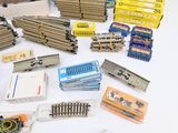 a lot of different types of train parts on the table