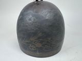 a black vase with a bird on top of it