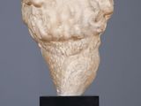 an image of a sculpture of a man ' s head on top of a wooden table