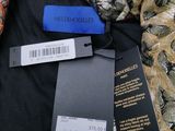 two tags on a black shirt with a gold and orange paisley pattern