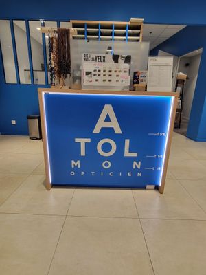 la réception d'un magasin avec une enseigne bleue sur laquelle on peut lire « a tol »