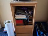 a small cabinet with a printer on top of it next to a trash can