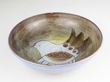 a small bowl with a bird painted on it