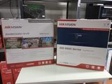 boxes on a table in a store with a television in the background