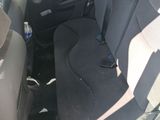 a black seat in the back of a car with a bottle of water in it