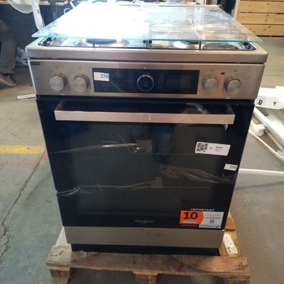 a stove that is sitting on a pallet in a warehouse