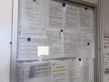 a picture of a bulletin board with a lot of papers on it