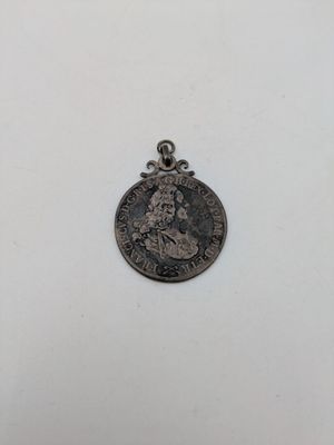 a silver coin with a picture of a woman on it