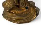 brass statue of a fish with a long tail on a white background