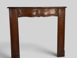 an old wooden fireplace mantle with carvings on the top
