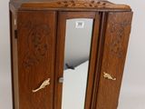 a small wooden cabinet with a mirror on top of it