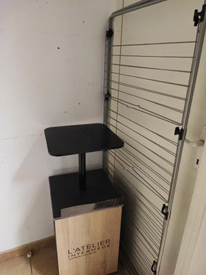 a wooden box sitting next to a metal rack in a room